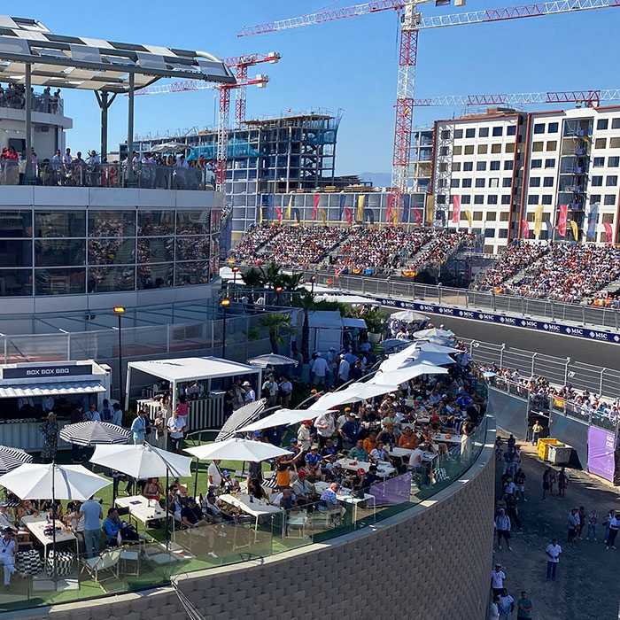 MADRING hospitality suites and terraces beside the circuit, with cranes in the background