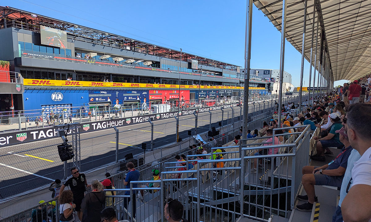 Madring-F1-circuit-LDA-references-12 Spectators in a covered MADRING grandstand overlooking the pit lane and team garages